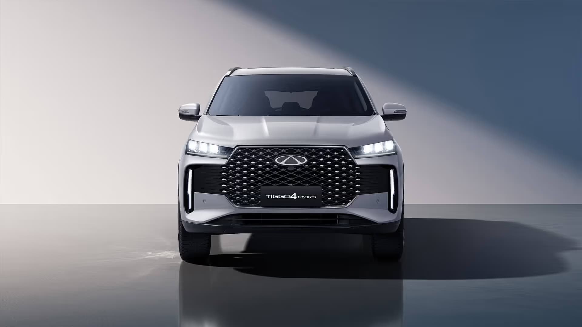A Chery SUV lit against a dark studio backdrop